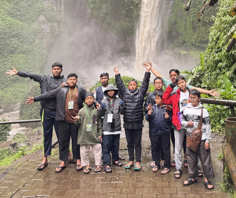 Peserta berfoto bersama di depan air terjun pada kegiatan BBA sebelumnya.